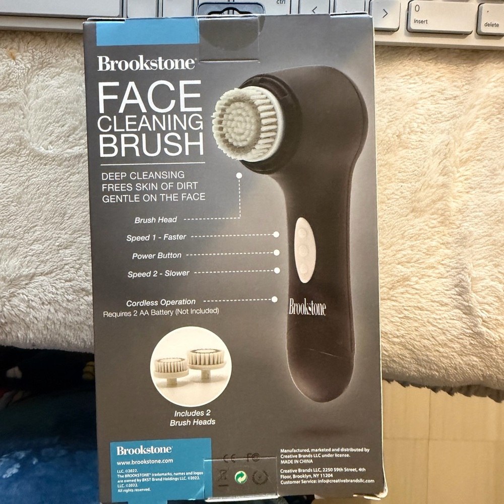 Brookstone Black Face Cleaning Brush with White Brush Heads